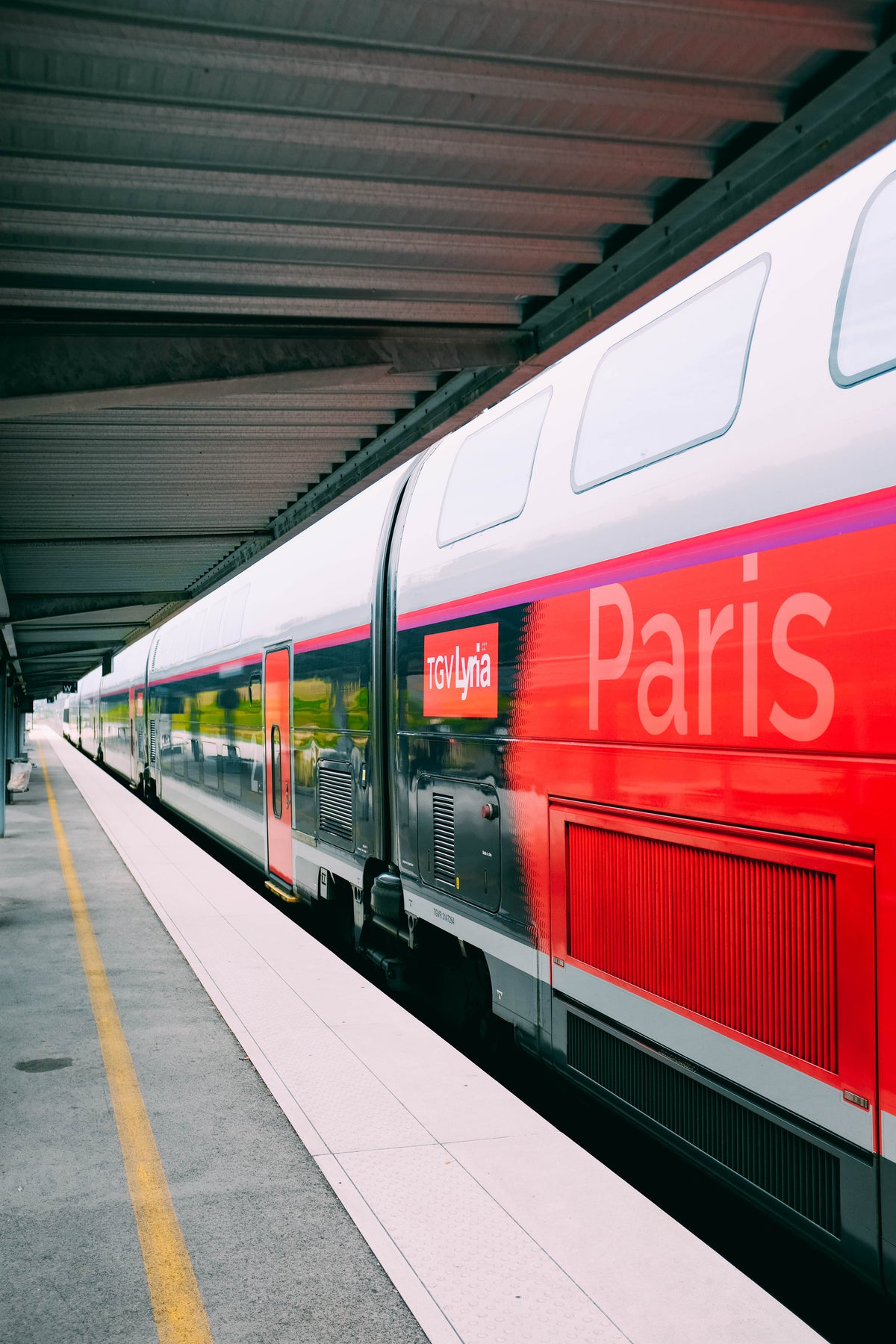 A red train at a station — public transportation use case